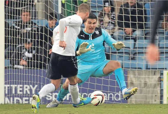  ??  ?? Kyle Letheren was a fan favourite during his time at Dens, seen here stopping an effort from future Dark Blues striker Rory Loy against Falkirk.