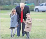  ?? REUTERS ?? US President Donald Trump walks with his grandchild­ren Arabella and Joseph at the White House on Friday.