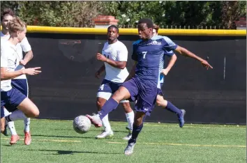  ?? Photo courtesy TMU Athletics/Dhon Wellons ?? TMU’s Humphrey Mahowa attempts to keep control of the ball against Menlo. This week, Mahowa earned GSAC men’s soccer offensive player of the week honors for the second time.