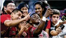  ?? JOHN AMIS ?? Atlanta United defender George Bello takes a selfie with fans after a 2-1 Atlanta victory against the New England Revolution in October.