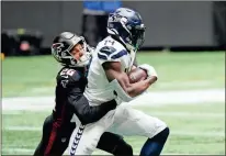  ?? AP - Brynn Anderson ?? Falcons cornerback Isaiah Oliver tackles Seahawks wide receiver DK Metcalf during the first half of last weekend’s season opener.