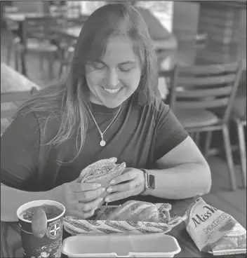  ?? LOANED PHOTO ?? A FIREHOUSE SUBS customer tries the newly introduced BBQ Cuban Sub. A portion of every purchase at the restaurant benefits the Firehouse Subs Public Safety Foundation, which is celebratin­g First Responders Month during October.