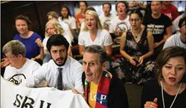  ?? TAMIR KALIFA / AMERICAN-STATESMAN ?? Austin City Council Member Greg Casar (second from left), the Rev. Chuck Freeman (second from right) and other protesters refuse to leave a state building in Austin during a sit-in demonstrat­ion Monday against SB 4.