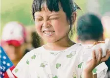  ?? Shuran Huang/New York Times ?? Jeanne Han eats ice cream Saturday near the Washington Monument. In Washington, D.C., cooling centers were opened.