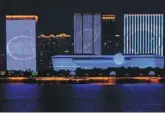  ?? YIN DONGXUN / XINHUA ?? Three buildings in Hangzhou combine to display the G20 logo on