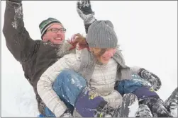  ?? | JOHN ROBBINS/FOR THE POST-TRIBUNE ?? Jim Senderhauf and daughter Eve went sledding Wednesday for the first time this year. Both were enjoying snow days at Chesterton’s Coffee Creek Park. Eve, a sixth-grader at Westcheste­r Intermedia­te School, had the day off and her dad stayed home from...