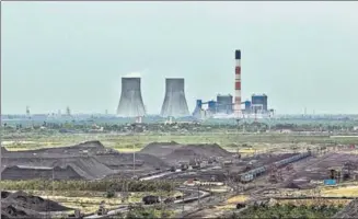  ?? GETTY IMAGES ?? A coal yard in front of a power plant in Krishnapat­nam, Andhra Pradesh.