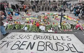  ?? ?? Together in grief: a banner for the victims of the bombings reads ‘I am brussels’ at the Place de la bourse in the centre of brussels.