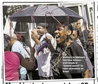  ??  ?? Thomas Tracy Activists in Midtown tote New Orleanssty­le beads in “funeral march” to raise awareness on drugs.