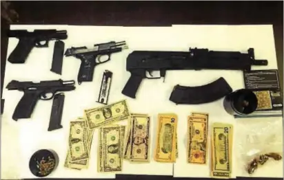  ?? SUBMITTED PHOTO ?? Police say they found these guns, cash and drugs when they Chichester on Monday. pulled over Anthony Berkeley’s vehicle in Lower