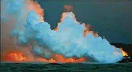  ??  ?? A steam plume rises and lava glows as it enters the Pacific Ocean after flowing Tuesday from a Kilauea volcano fissure. Laze, a word combinatio­n of lava and haze, contains hydrochlor­ic acid steam along with volcanic glass particles.