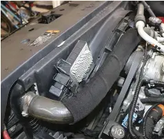  ??  ??  The TCM will need to be unbolted and set aside, along with the upper fan shroud, radiator breather/ overflow hose and both transmissi­on cooler lines. We’ll replace the upper coolant hose with the powder-coated hard line from HSP that will make a great match to our previously installed Max Flow turbo piping kit.