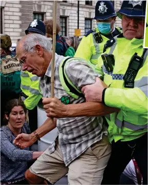  ??  ?? Disruption: An Extinction Rebellion activist is moved on yesterday