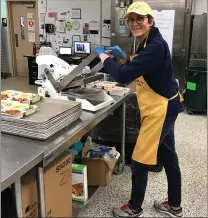  ?? PETE BANNAN - MEDIANEWS GROUP ?? Phoebe Kitson-Davis, COVID-19 Emergency Response Director for the Chester County Food Bank, seals meals at the Eagleview kitchen and warehouse.