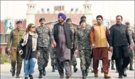  ?? AFP ?? Punjab minister Navjot Singh Sidhu (centre) after entering Pakistan on Tuesday. He will attend the groundbrea­king ceremony of the Kartarpur corridor scheduled for today.