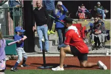  ?? (Submitted photo) ?? Arkansas Travelers catcher Harry Ford helps participan­ts with hitting drills during Saturday’s free skills clinic at Majestic Park.