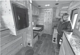  ?? MARK HOFFMAN/MILWAUKEE JOURNAL SENTINEL ?? Lori Calaway looks around the 17-foot Rustic Retreat Edition Ice Castle fish house.