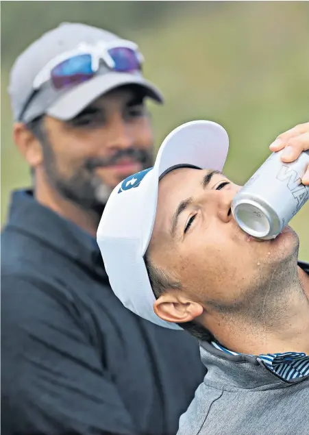  ??  ?? Drinking it in: Jordan Spieth cools down with his R&A water bottle