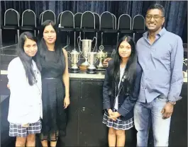  ??  ?? Jade Naidoo, left, with her mother Yvette, twin sister Amber and dad Vincent at an awards ceremony at their school.