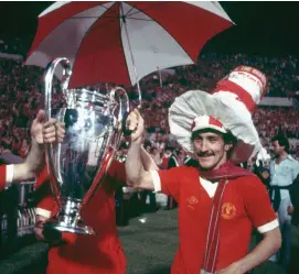  ??  ?? Terry McDermott celebrate with the trophy after their victory over Borussia Moenchengl­adbach in the European Cup Final at the Olympic Stadium in Rome, 25th May 1977,