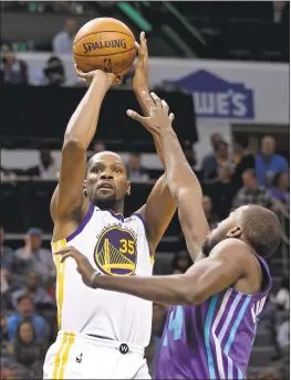  ?? CHUCK BURTON — ASSOCIATED PRESS ?? Durant takes a shot over Charlotte’s Michael Kidd-Gilchrist. Durant took control for the Warriors as they played without Stephen Curry (ankle) and Draymond Green (shoulder).