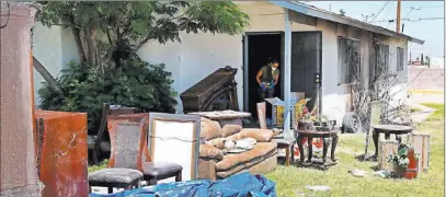  ?? Bizuayehu Tesfaye ?? Las Vegas Review-journal Furniture is clustered outside a Las Vegas house that was damaged in a fire likely caused by illegal fireworks.