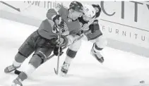  ?? LYNNE SLADKY | AP ?? Panthers center Sam Bennett (9) and Columbus Blue Jackets defenseman Andrew Peeke go for the puck during Monday’s game.