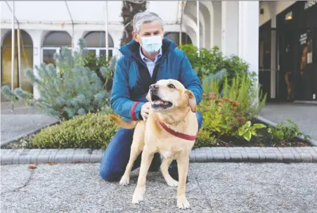  ?? REUTERS ?? Andrew Wilkinson with his dog Rosie: The Liberal leader is urging supporters to be patient and wait for the results of mail-in ballots.