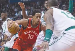  ?? The Canadian Press ?? Toronto Raptors guard DeMar DeRozan (10) drives the lane towards Boston Celtics’ Marcus Morris during second-half NBA action in Toronto on Tuesday.