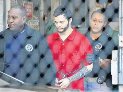  ?? C.M. GUERRERO/MIAMI HERALD ?? Esteban Santiago is moved from the Broward County main jail in Fort Lauderdale after he was arraigned in federal court Monday.