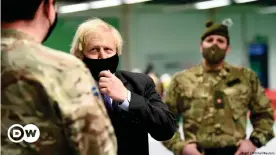  ??  ?? Johnson meets troops as they set up a vaccinatio­n center in the Castlemilk district of Glasgow