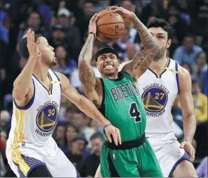 ?? BEN MARGOT / AP ?? Boston Celtics’ Isaiah Thomas squeezes between Golden State defenders Stephen Curry (left) and Zaza Pachulia on Wednesday night in Oakland, California. Thomas scored 25 points as the Celtics beat the sloppy Warriors 99-86.