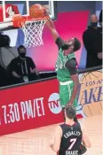  ?? USA TODAY SPORTS ?? Celtics guard Jaylen Brown dunks against the Heat.