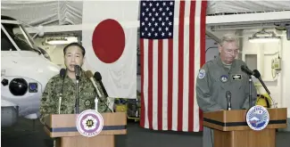  ?? The Yomiuri Shimbun ?? Gen. Koji Yamazaki, chief of staff of the Self-Defense Forces’ Joint Staff, left, and U.S. Lt. Gen. Ricky Rupp hold a press conference Monday in the hanger of destroyer Izumo in the Pacific Ocean.