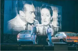  ?? Jason Armond Los Angeles Times ?? A VIDEO SCREEN punctuates the performanc­es of Arturo Chacón-Cruz as Edgardo and Amanda Woodbury in the title role of “Lucia di Lammermoor.”