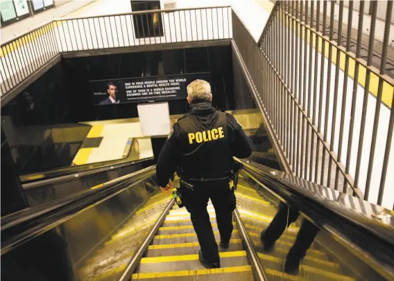  ?? Photos by Jessica Christian / The Chronicle ?? BART Officer Eric Hofstein heads down stairs to the Civic Center Station platform. Hofstein and fellow officers have deployed Narcan 58 times since June 2019.