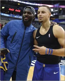  ??  ?? Former Dallas Cowboys receiver Dez Bryant, left, poses for a photo with Stephen Curry after receiving the Warriors star’s autographe­d jersey.