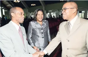  ?? RUDOLPH BROWN/ PHOTOGRAPH­ER ?? The Reverend Dr Stevenson Samuels (right), chairman of the National Leadership Prayer Breakfast Committee, greets Chief of Defence Staff, Brigadier Rocky Meade, while Chief Justice Zaila McCalla looks on at a service at the Church of the Open Bible on...