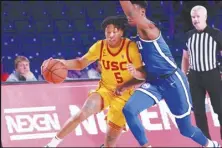  ?? ?? Bahamas Visual Services via AP USC’s Boogie Ellis drives against BYU’s Jaxson Robinson during an NCAA college basketball game on Wednesday in the Battle 4 Atlantis at Paradise Island, Bahamas. USC won 82-76.