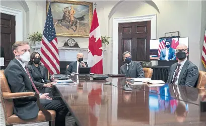  ?? EVAN VUCCI THE ASSOCIATED PRESS ?? U.S. President Joe Biden, back, holds a virtual bilateral meeting with Prime Minister Justin Trudeau, onscreen, on Tuesday.