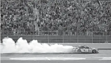  ?? AP Photo/Chuck Burton ?? ■ Kyle Busch celebrates after winning the NASCAR Cup Series on Sunday at Charlotte Motor Speedway in Charlotte, N.C.