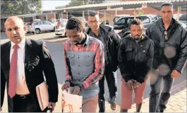  ??  ?? Murder accused Bongani Siyabonga Mhlongo and Sizwe Mthethwa walk into the Pietermari­tzburg High Court on Monday. They were arrested by members of the KZN Provincial Task Team members, from left, Warrant Officer Rajen Govender, Sergeant Denver Parbhu, and Warrant Officer Praved Maharaj.