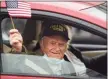  ?? Brian A. Pounds / Hearst Connecticu­t Media ?? World War II veteran Matthew Pekata, 95, waves a flag as he is driven to a Veterans Day breakfast at the Baldwin Community Center in Stratford on Wednesday.