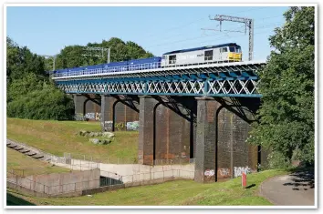  ?? JO CLOUGH. ?? In 2021, DC Rail resurrecte­d a long-defunct flow of sand traffic from Norfolk-Merseyside. On July 17 2021, 60046 crosses Carr Mill viaduct in St Helens with the 0803 Middleton Towers-Ravenhead.