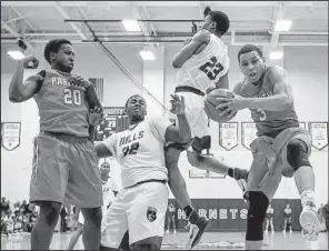  ?? Arkansas Democrat-Gazette/MITCHELL PE MASILUN ?? Little Rock Parkview’s Khalil Garland (far right) comes down with a rebound against two Mills defenders as teammate Kevin Cross (20) looks on Friday during the Patriots’ 57-55 overtime victory over the Comets in the championsh­ip game of the 5A-Central...