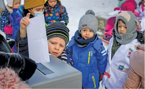  ?? Picture: AFP ?? HAVING
THEIR SAY. Preschoole­rs place their votes in a ballot box this week in Lausanne during a referendum, organised by private preschools network Educalis, aimed to ease young children into participat­ing in Switzerlan­d’s famed direct democratic system.