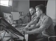  ?? CP PHOTO ?? Michael Latsky, right, plays a video game with his son Robert Latsky at his son’s office work space in Toronto on Thursday, May 3, 2018.