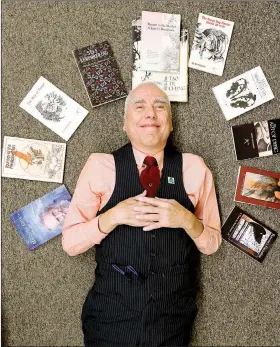  ?? Arkansas Democrat-Gazette/TOMMY METTHE ?? is surrounded by his books.