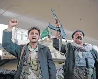  ?? AP PHOTO ?? Houthi Shiite fighters chant slogans as they guard a street leading to the residence of former Yemeni President Ali Abdullah Saleh, in Sanaa, Yemen, Monday. Saleh was killed by Shiite rebels, Monday as their forces battled for control of the capital,...