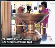  ??  ?? TRIBUTE Eternal flame at site honours Amritsar dead